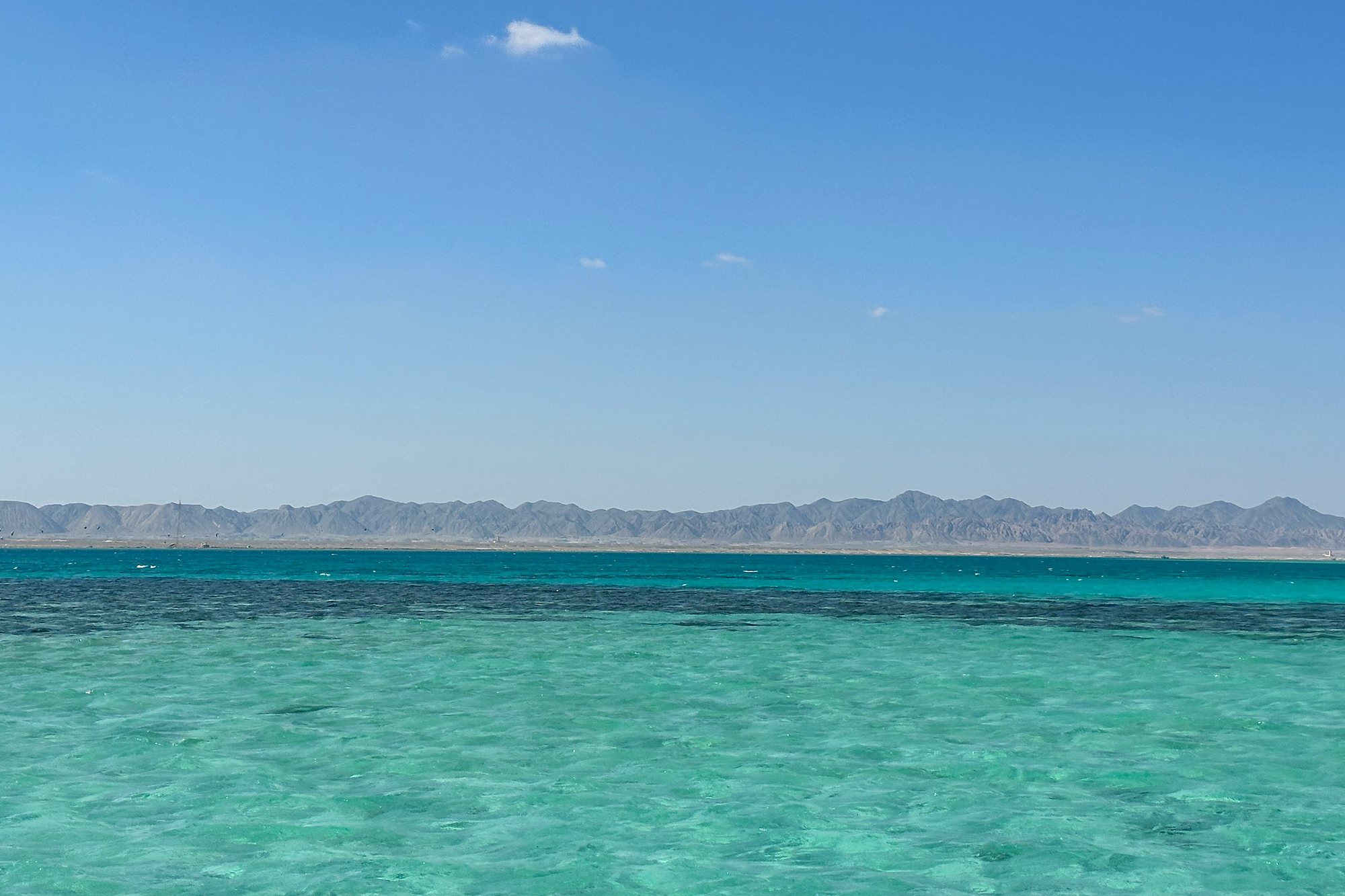 Turquoise Red Sea shallows below the mountains near El Gouna