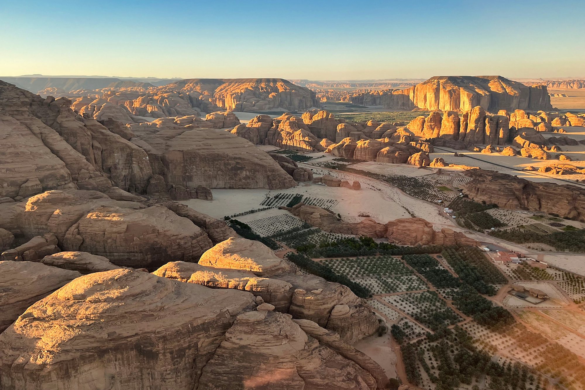 The sandstone canyons and palm oasis of AlUla from the air