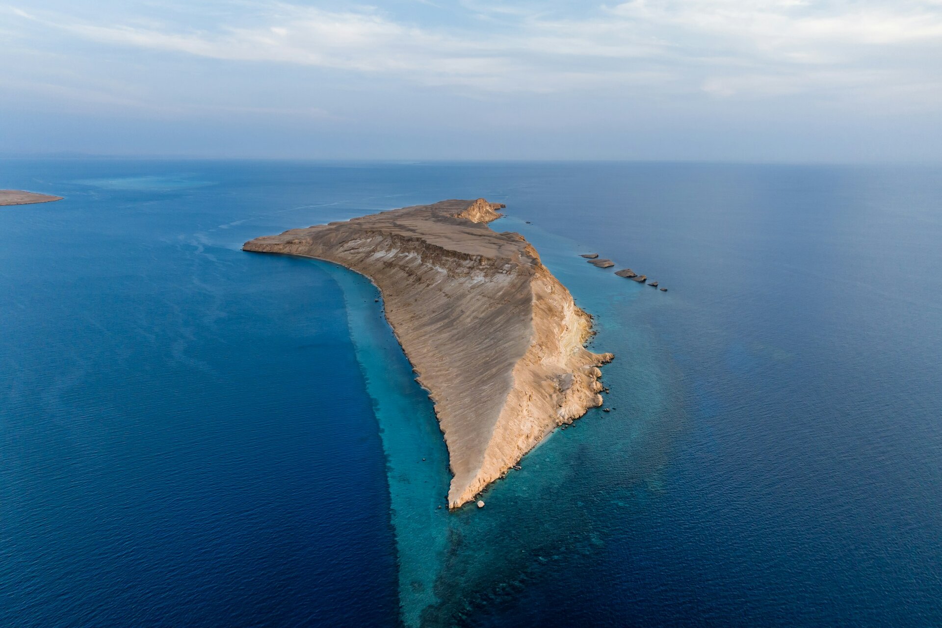 An island ringed by coral reef in the Red Sea off NEOM, Saudi Arabia