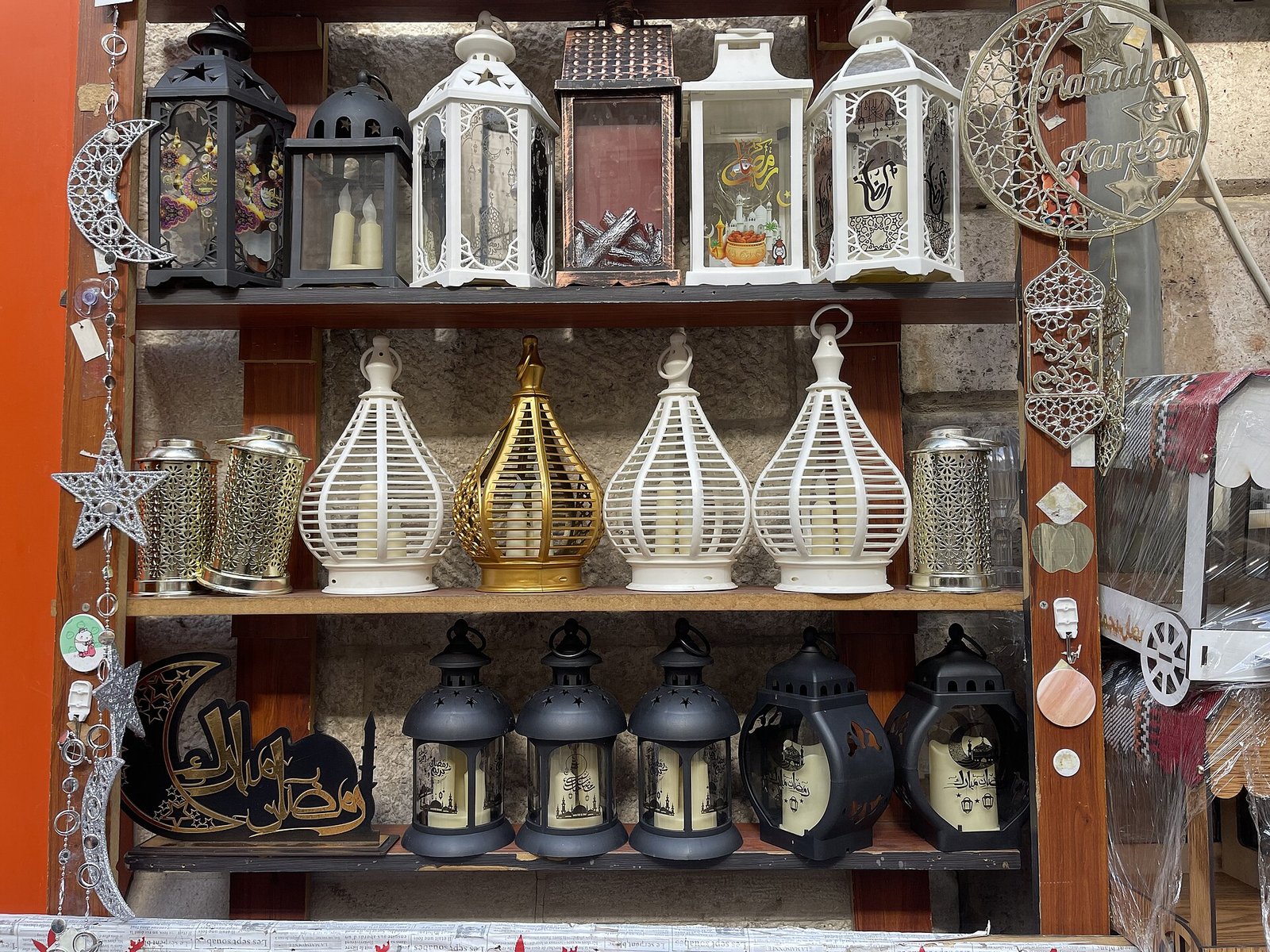 Shelves of brass, white and black Ramadan lanterns for sale in downtown Amman.