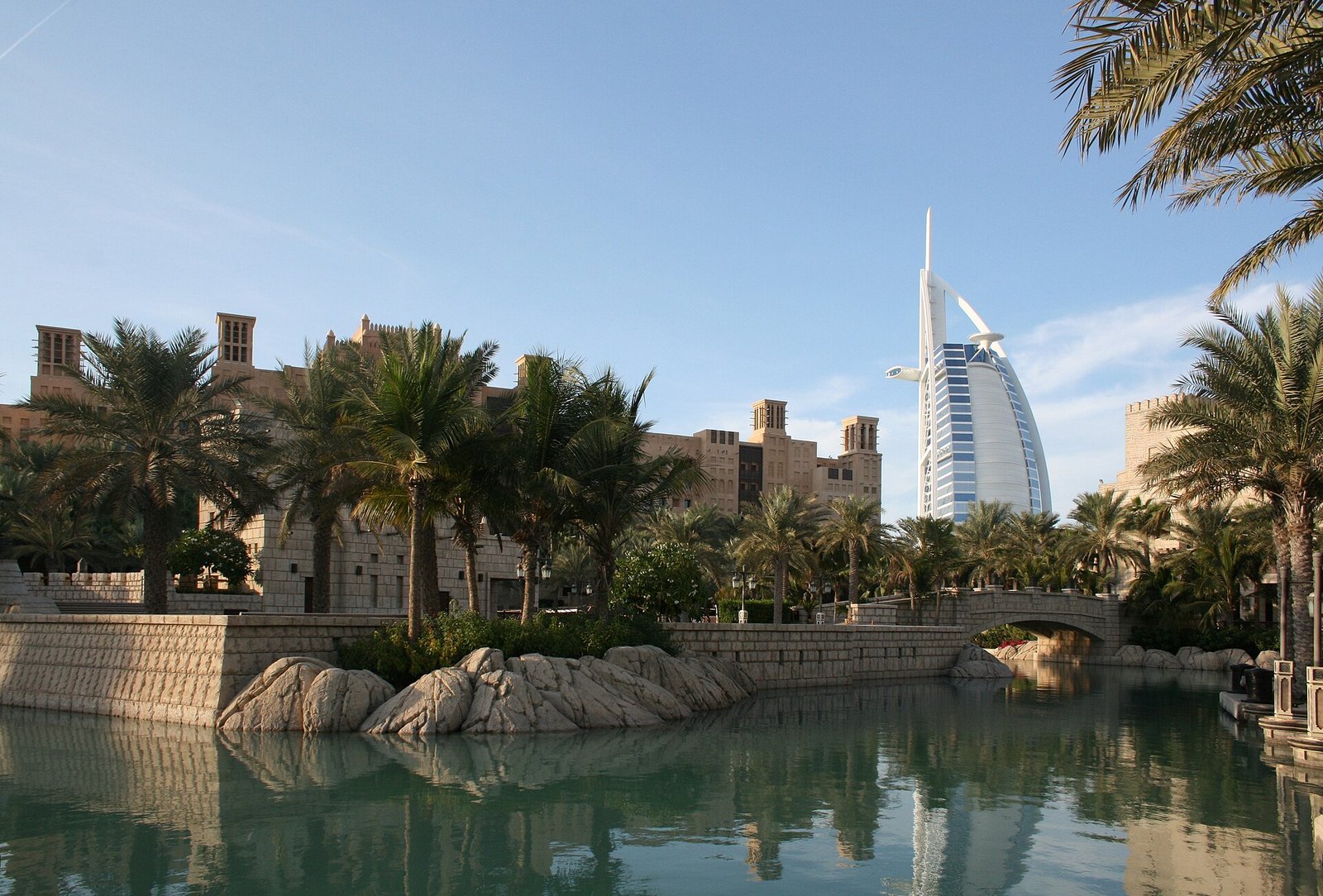 Palm-lined waterways at Madinat Jumeirah lead the eye to the sail of the Burj Al Arab, Dubai.