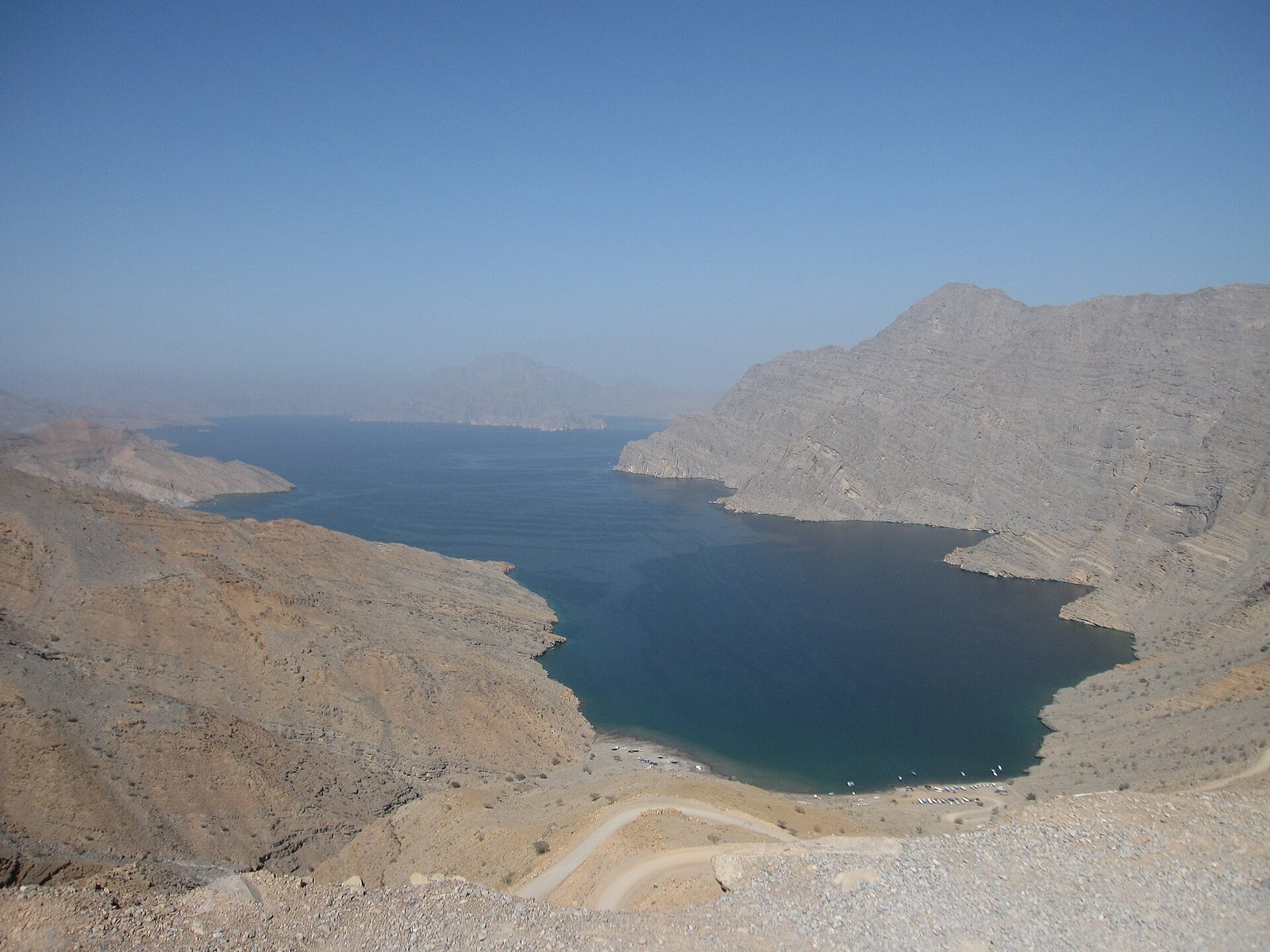 A deep blue fjord between bare mountains on the Musandam Peninsula, Oman