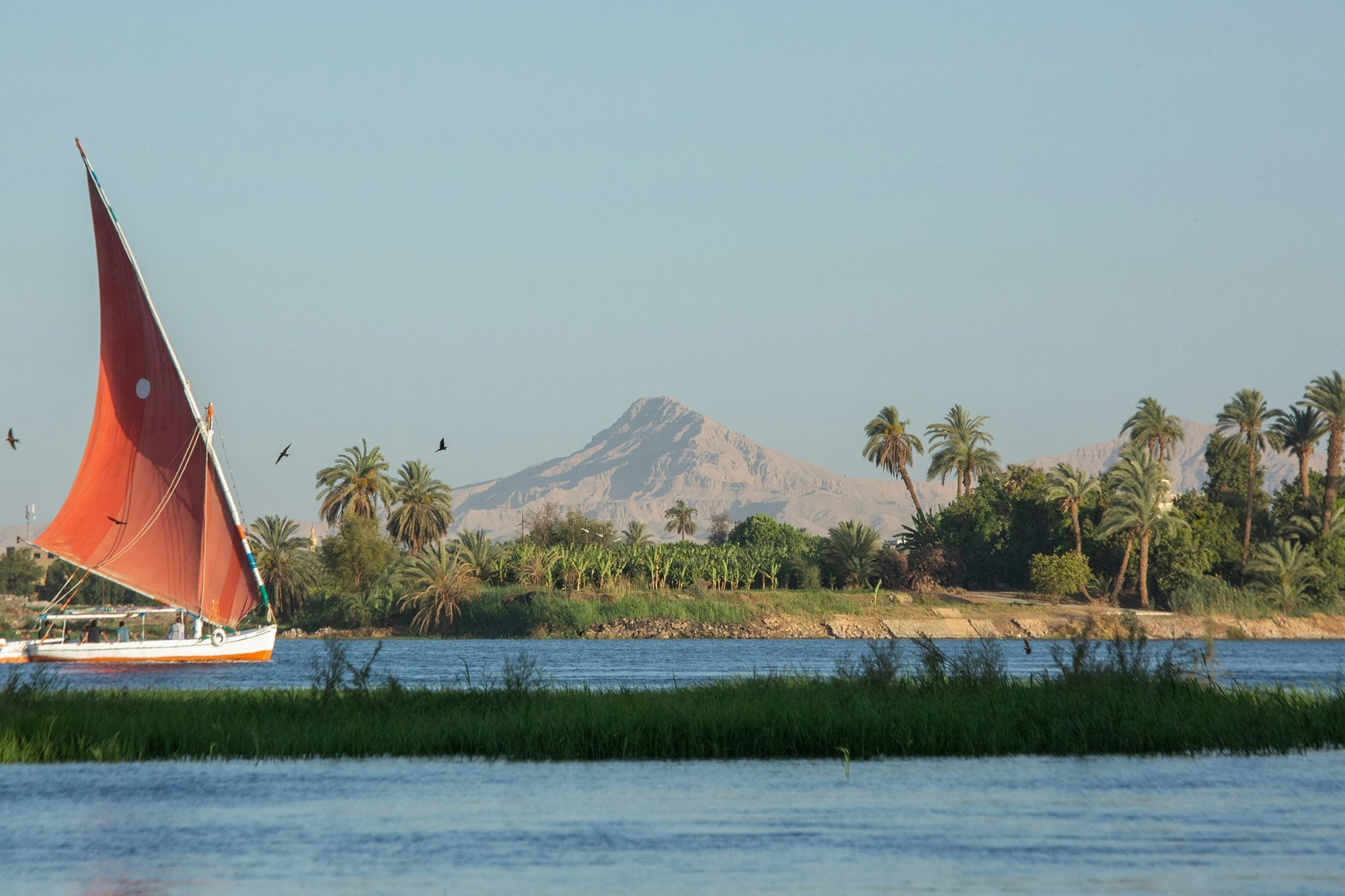 A felucca with a red sail on the Nile
