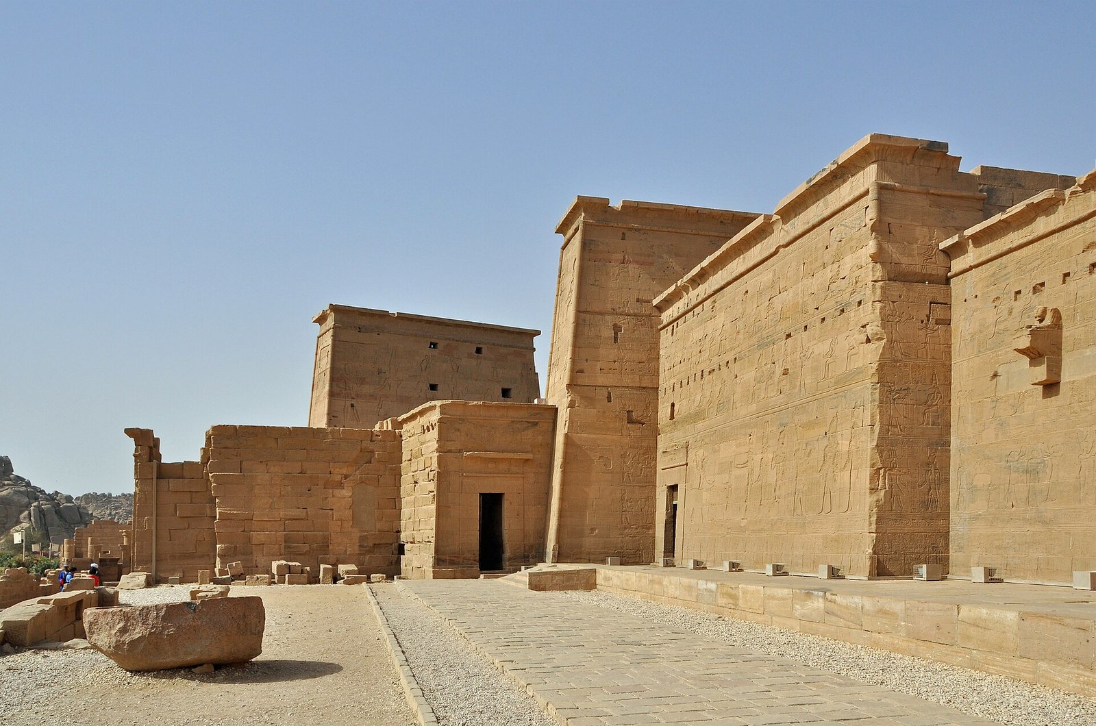 The sandstone pylons of the Temple of Isis at Philae, near Aswan, under a clear blue sky