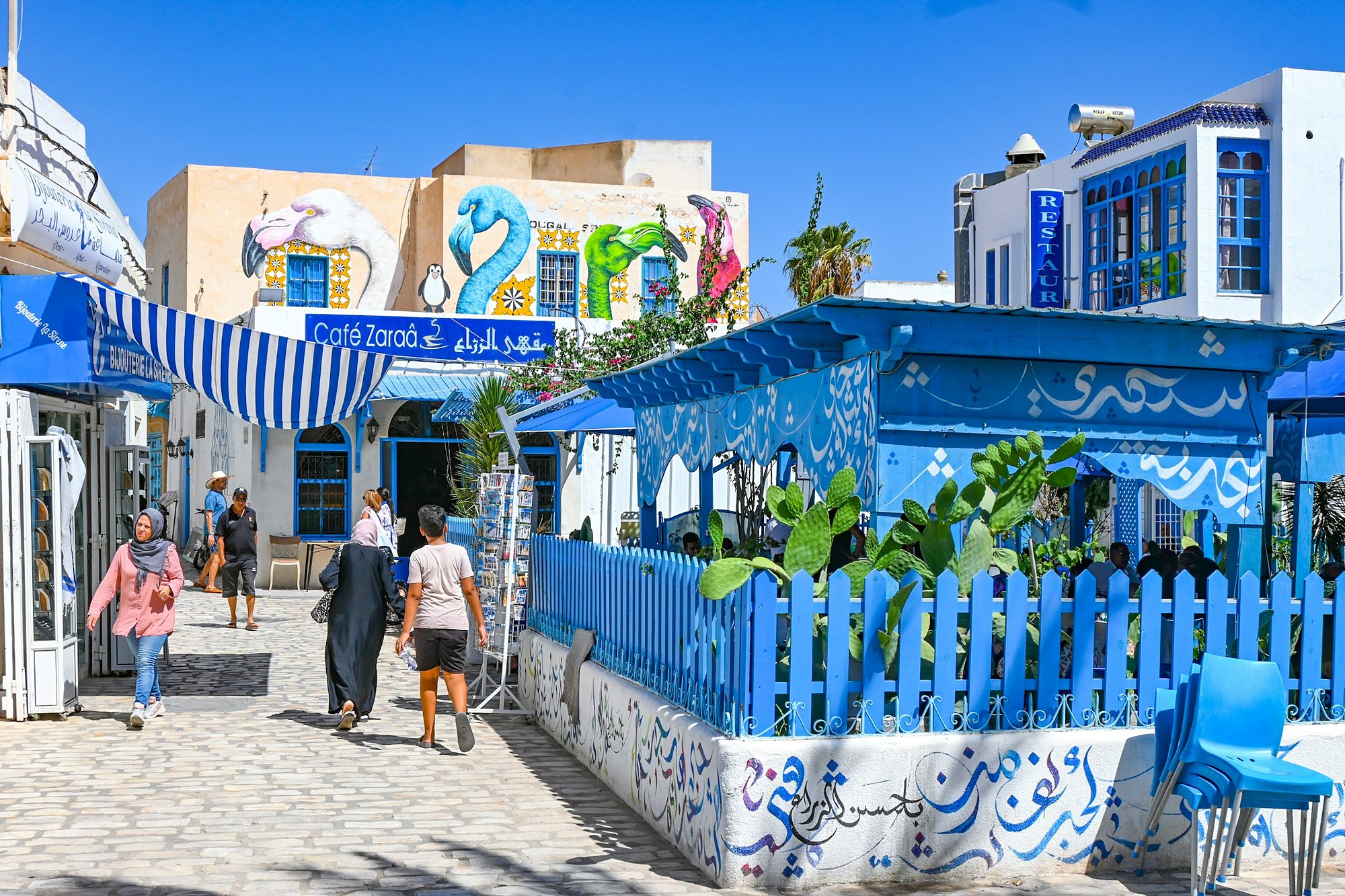 Blue cafes and street murals in Houmt Souk, Djerba