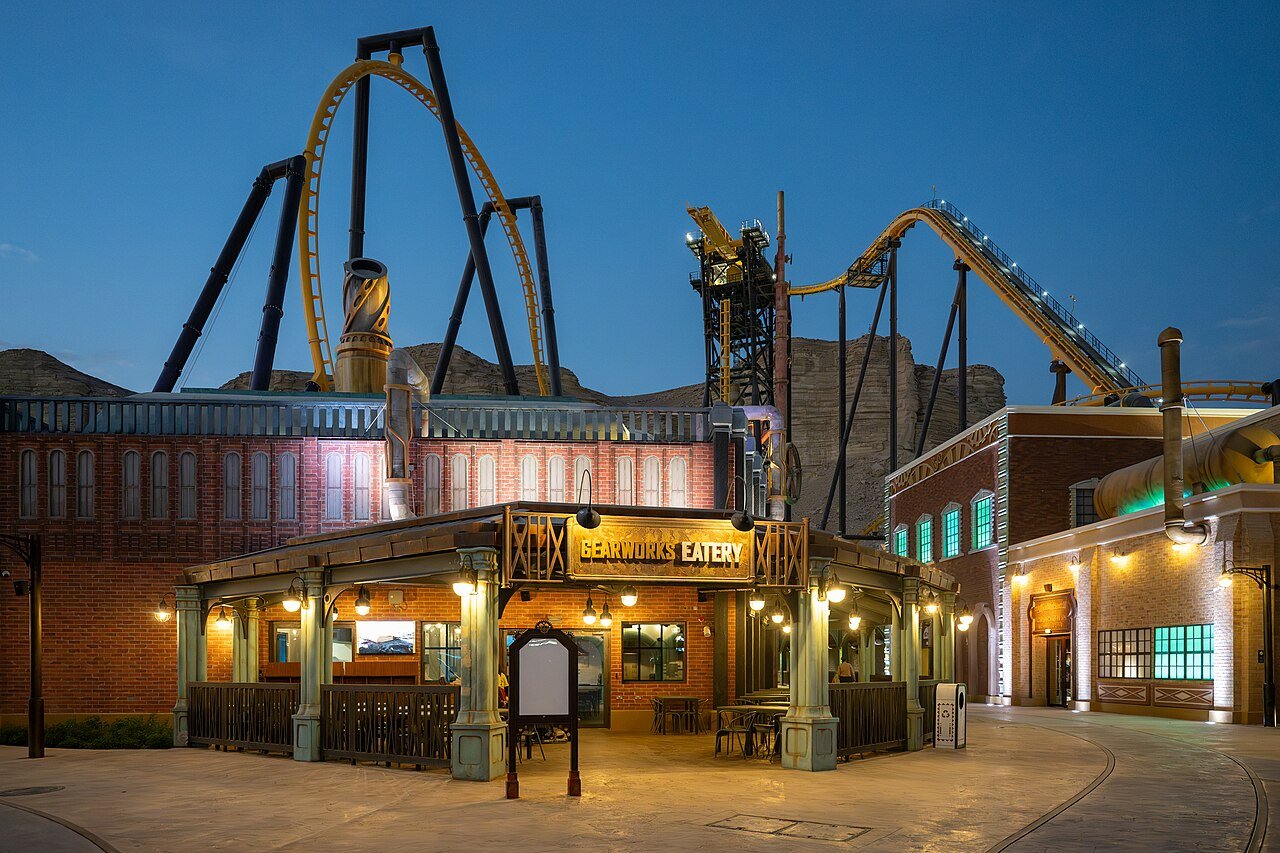 The roller coasters and lamplit streets of Six Flags Qiddiya City glowing at dusk southwest of Riyadh.