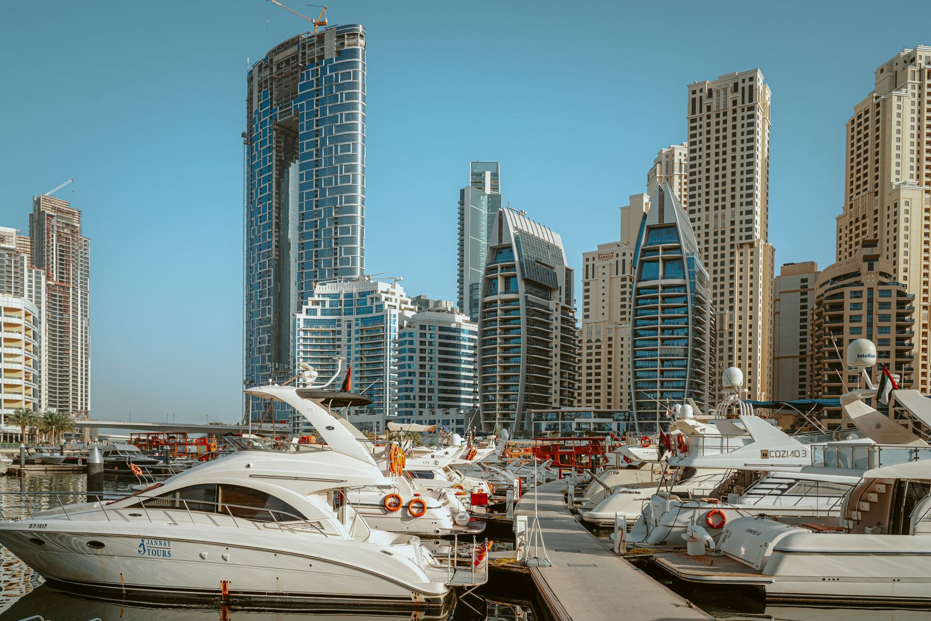 Motor yachts moored below the towers of Dubai Marina
