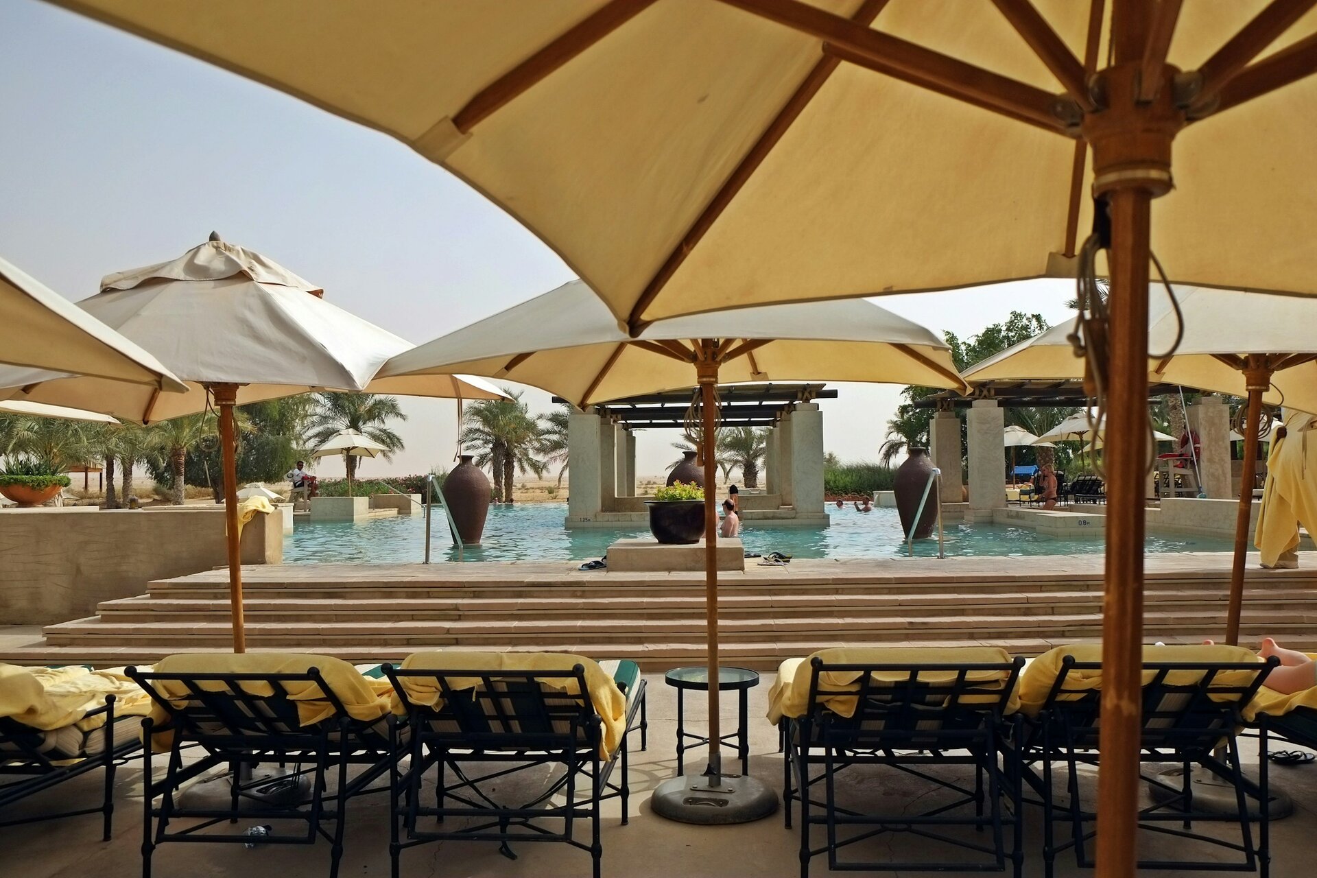 Parasols and loungers by the pool at Bab Al Shams desert resort, Dubai