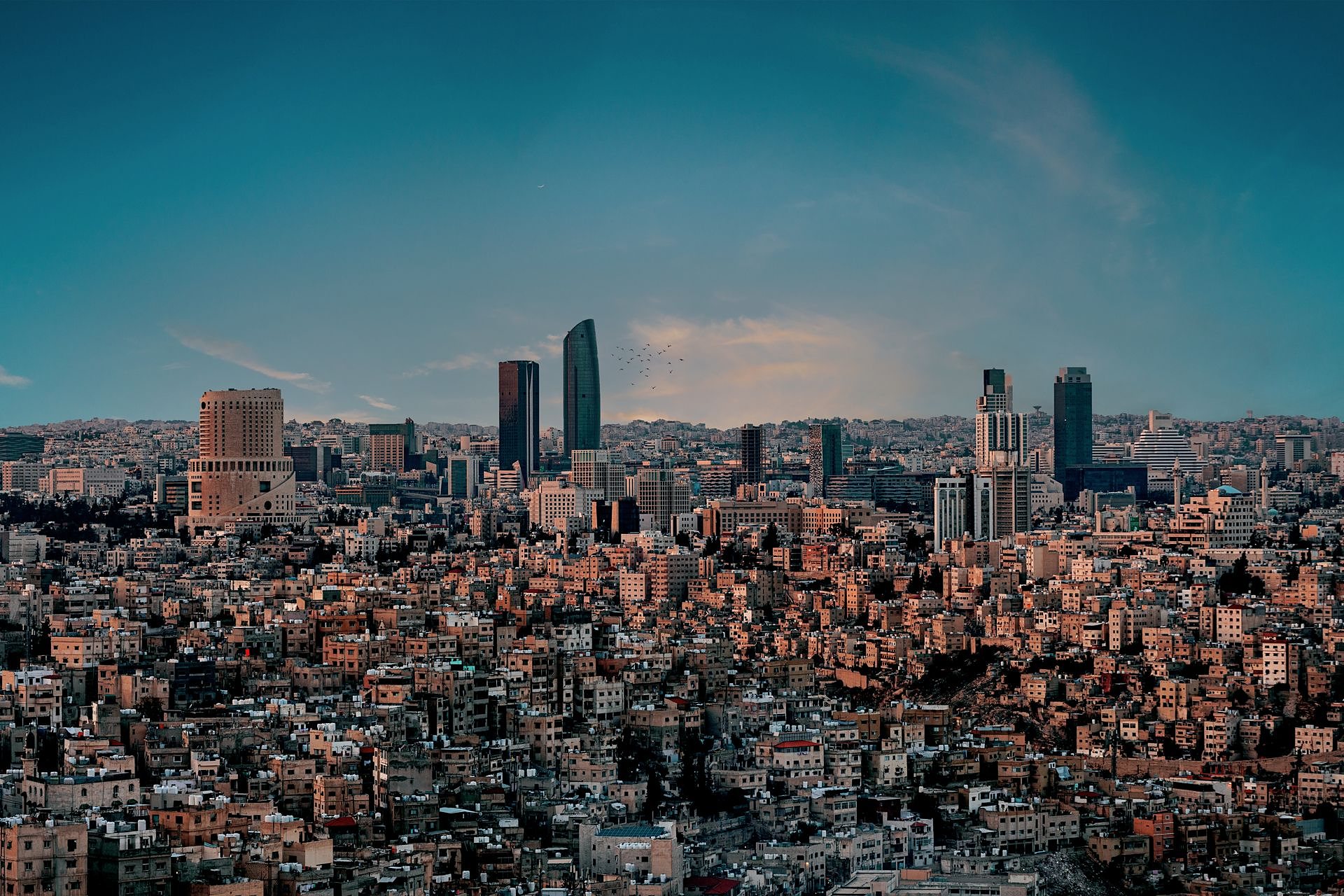 The hills and towers of Amman at dusk