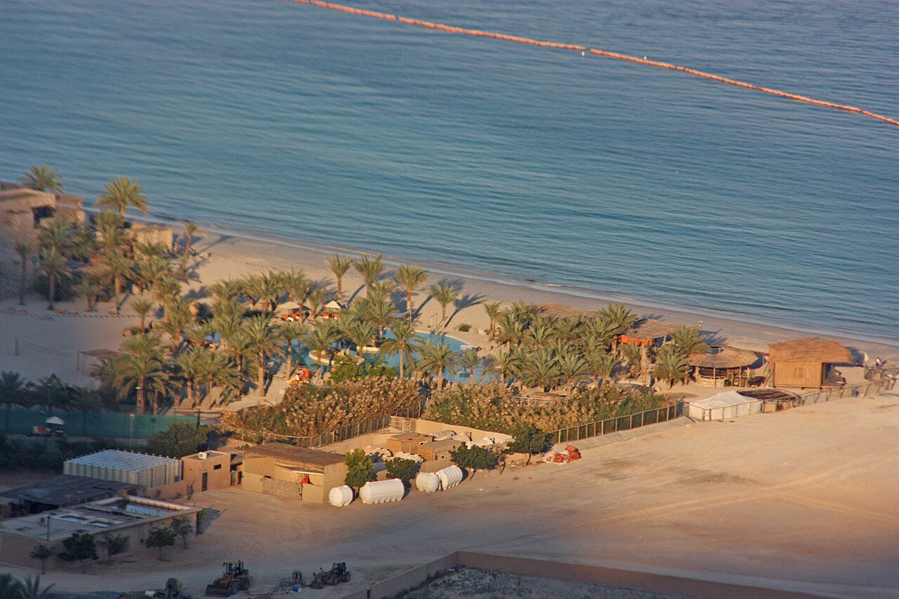 The palm-shaded beach villas of Six Senses Zighy Bay seen from the mountains above, Musandam.