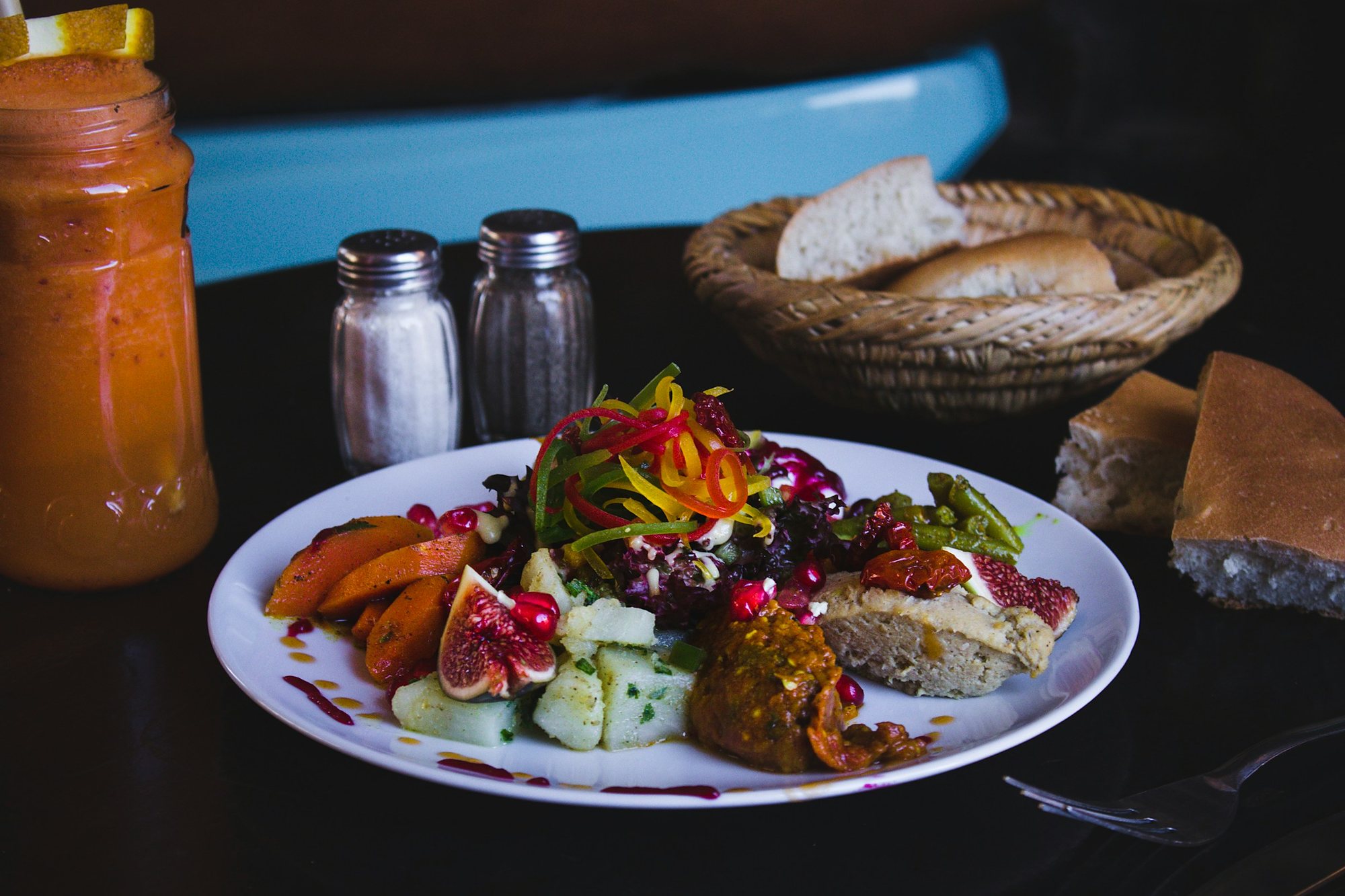 A plate of North African salads with figs and pomegranate, with fresh bread