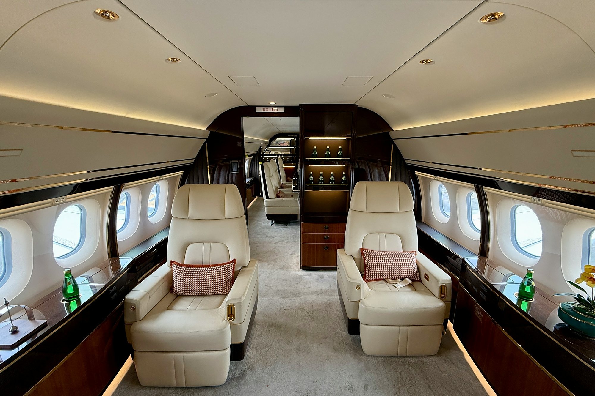 The cream leather seats and polished wood of a private jet cabin