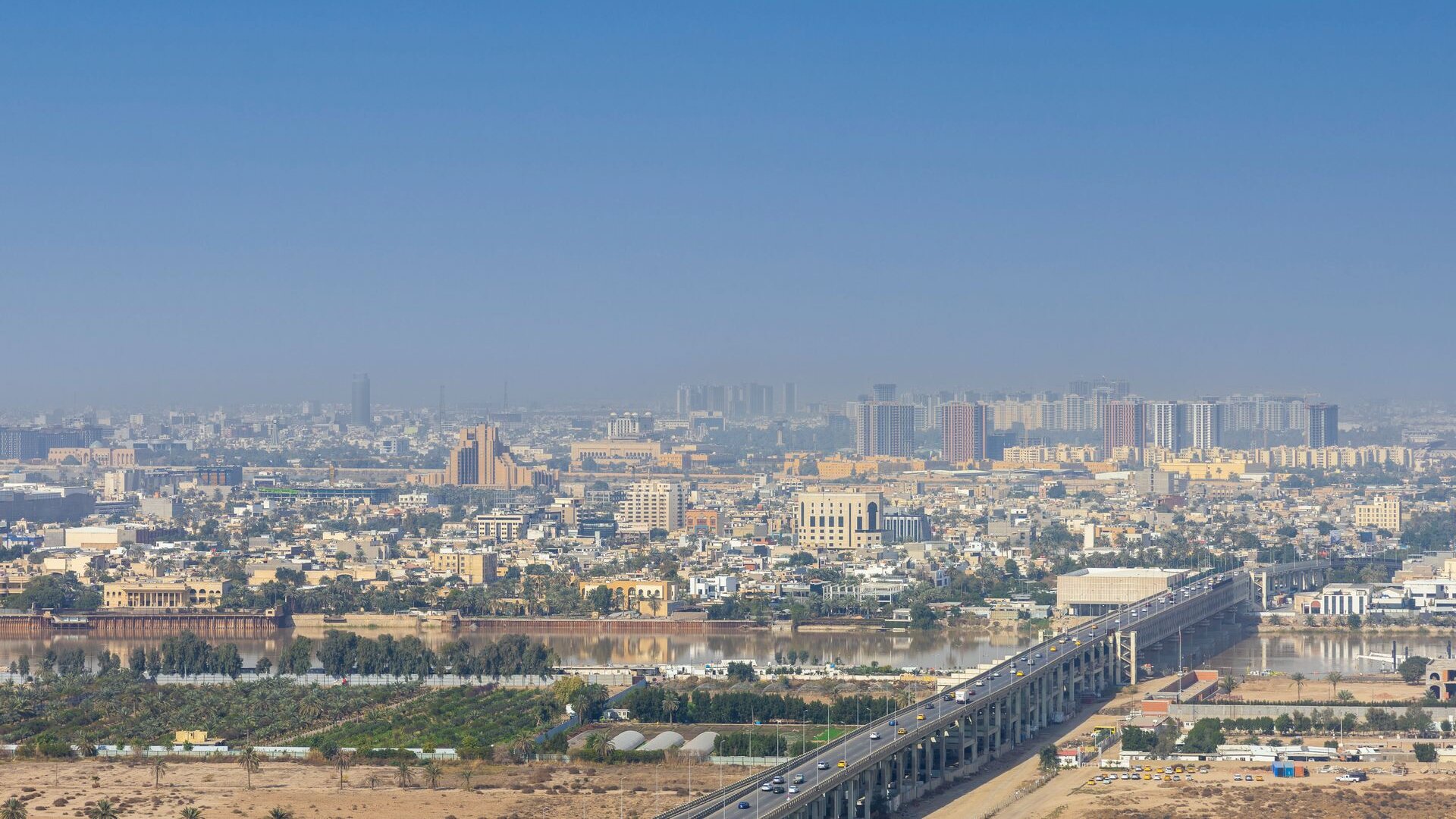 A highway bridge crossing the Tigris into Baghdad, new towers rising beyond