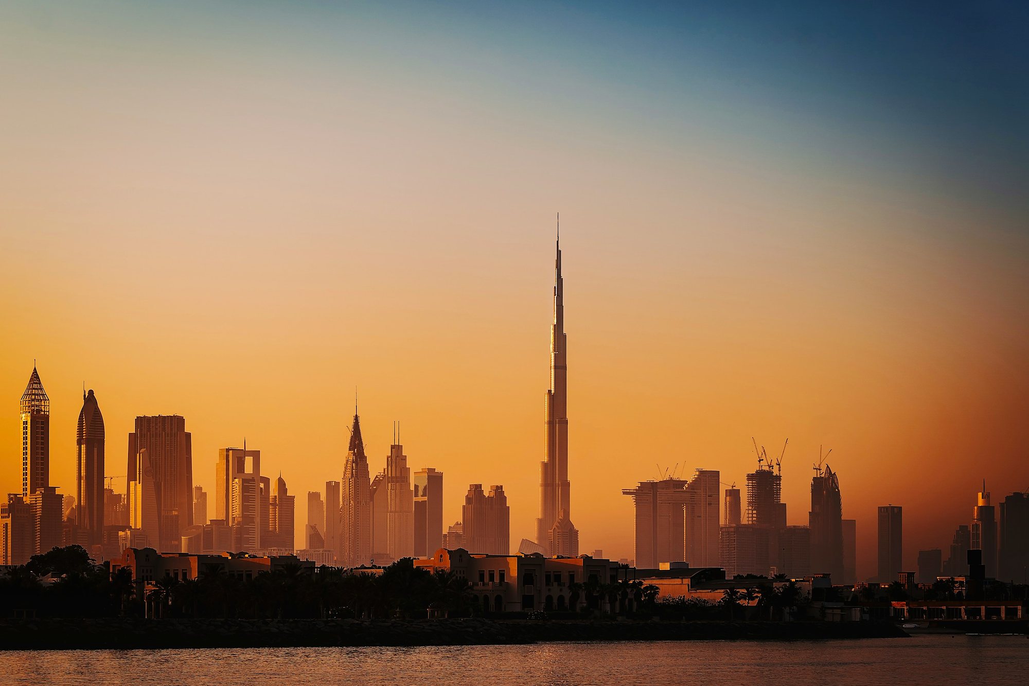 The Dubai skyline glowing gold at dawn