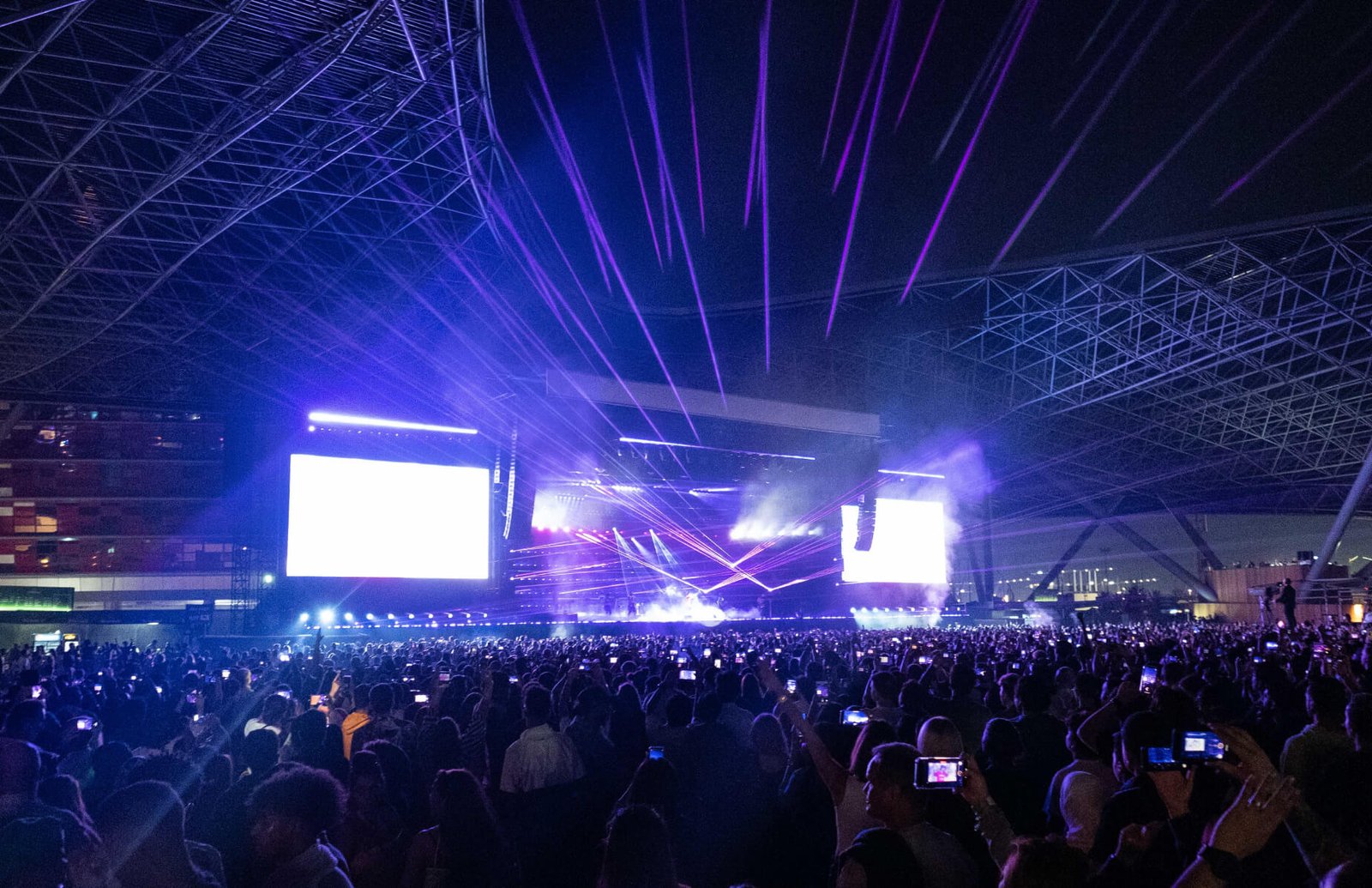Laser beams and stage screens lighting up a concert crowd at Etihad Park, the open-air venue on Yas Island, Abu Dhabi.
