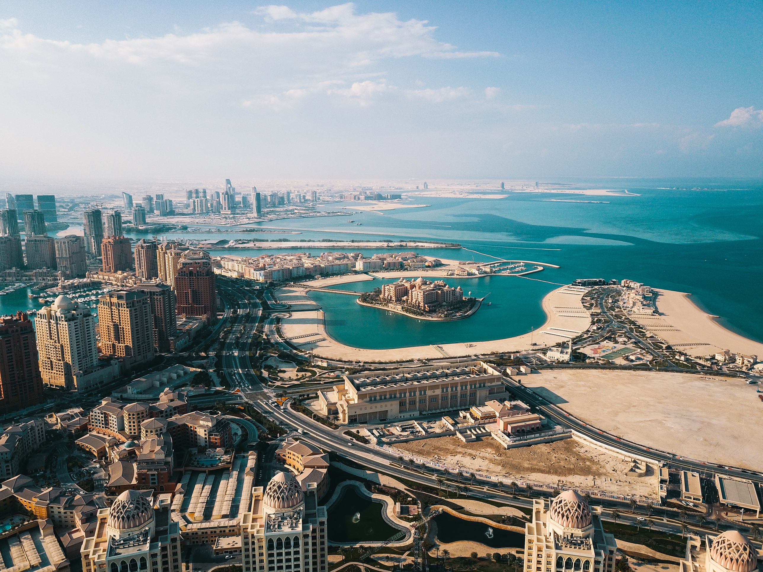 The Pearl-Qatar from the air, with Marsa Malaz Kempinski on its island and Lusail and West Bay beyond