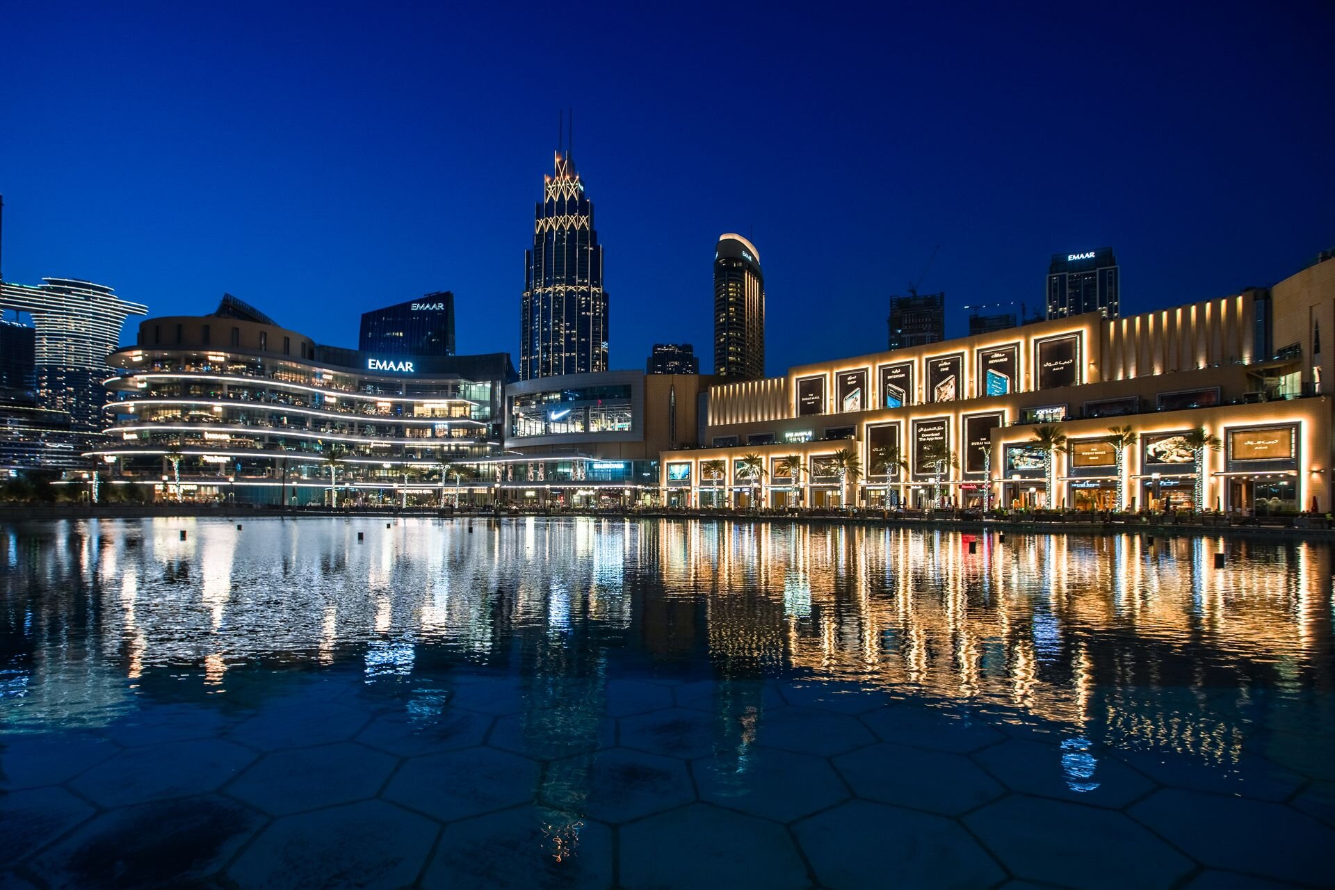 The Dubai Mall waterfront and Emaar towers reflected in the lake at blue hour