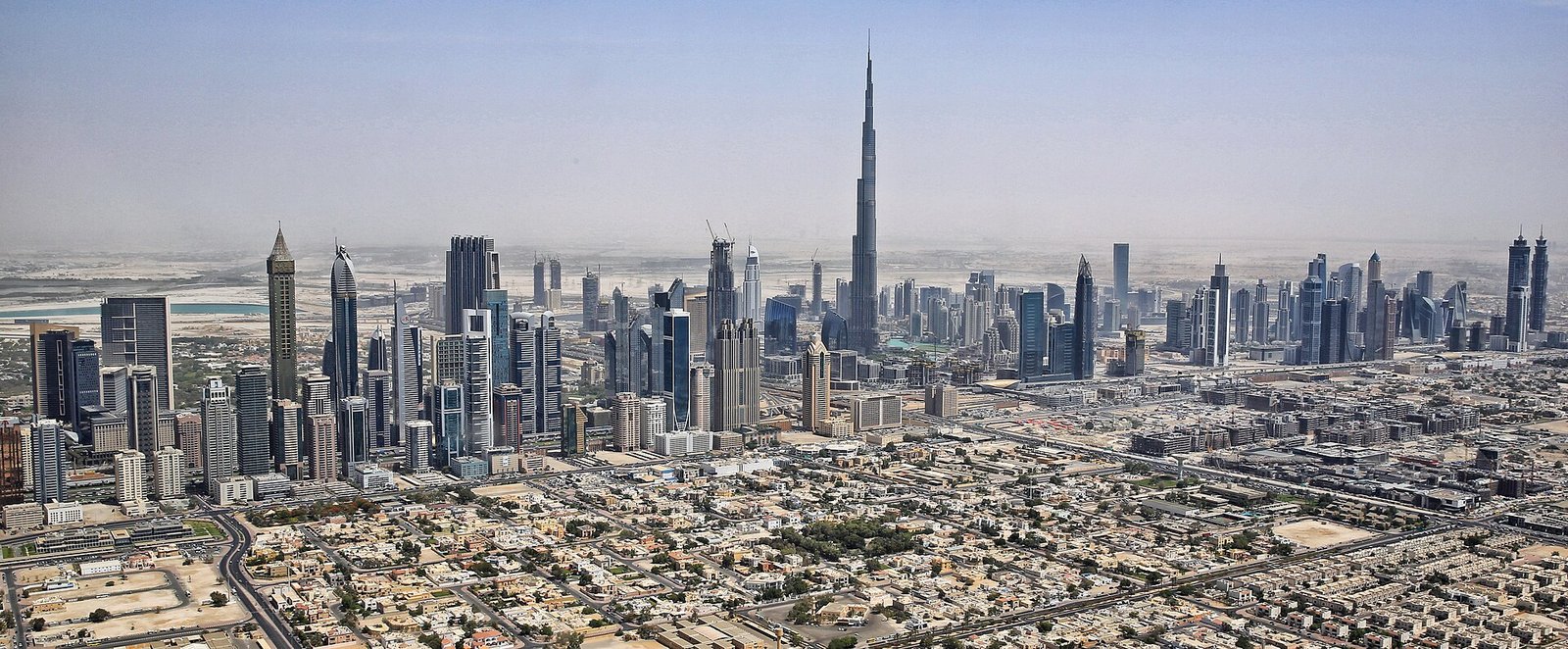 Downtown Dubai and the Burj Khalifa seen from a helicopter above the city.