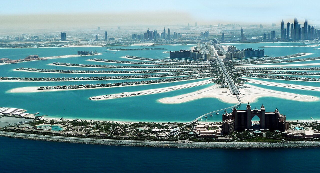 The fronds of Palm Jumeirah and Atlantis The Palm seen from the air, with the Dubai Marina skyline beyond.
