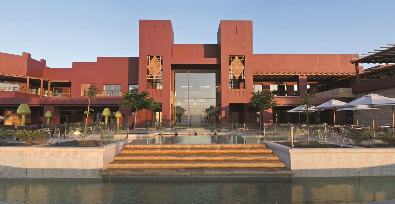 The terracotta facade and waterfront terrace of the Mövenpick resort at Tala Bay, Aqaba.