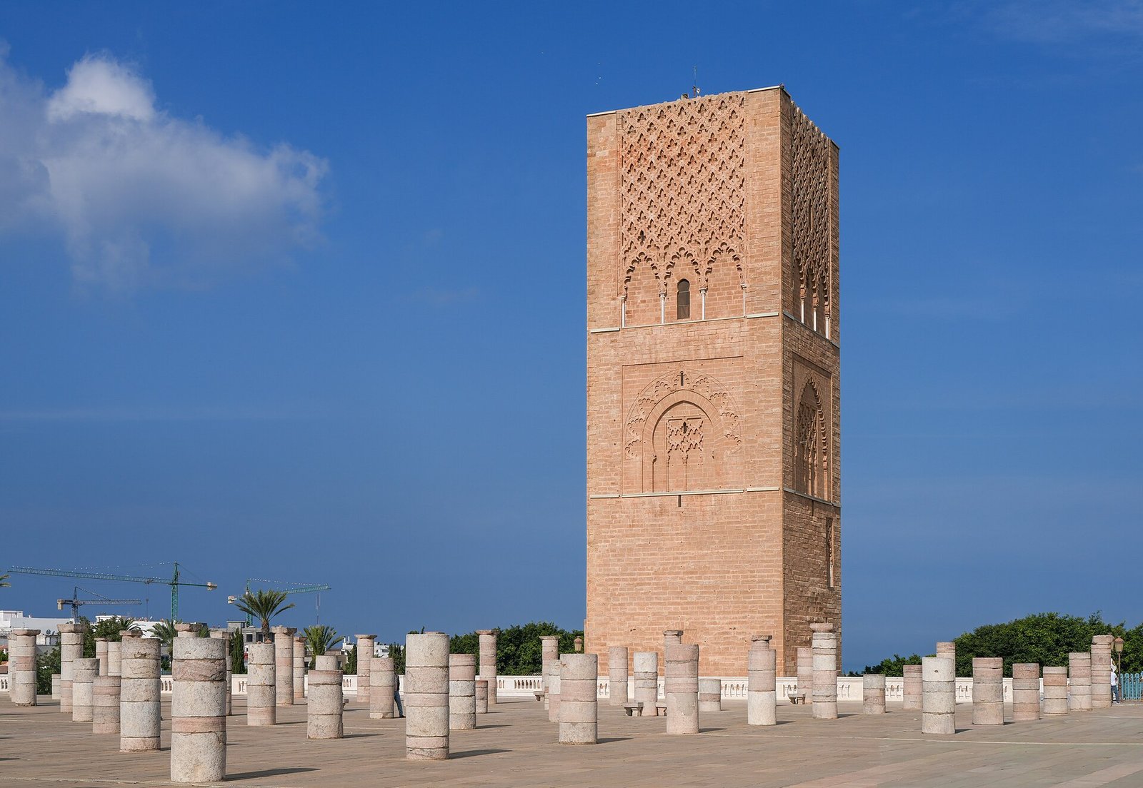 The twelfth-century Hassan Tower rises over rows of marble column bases under a deep blue sky in Rabat.