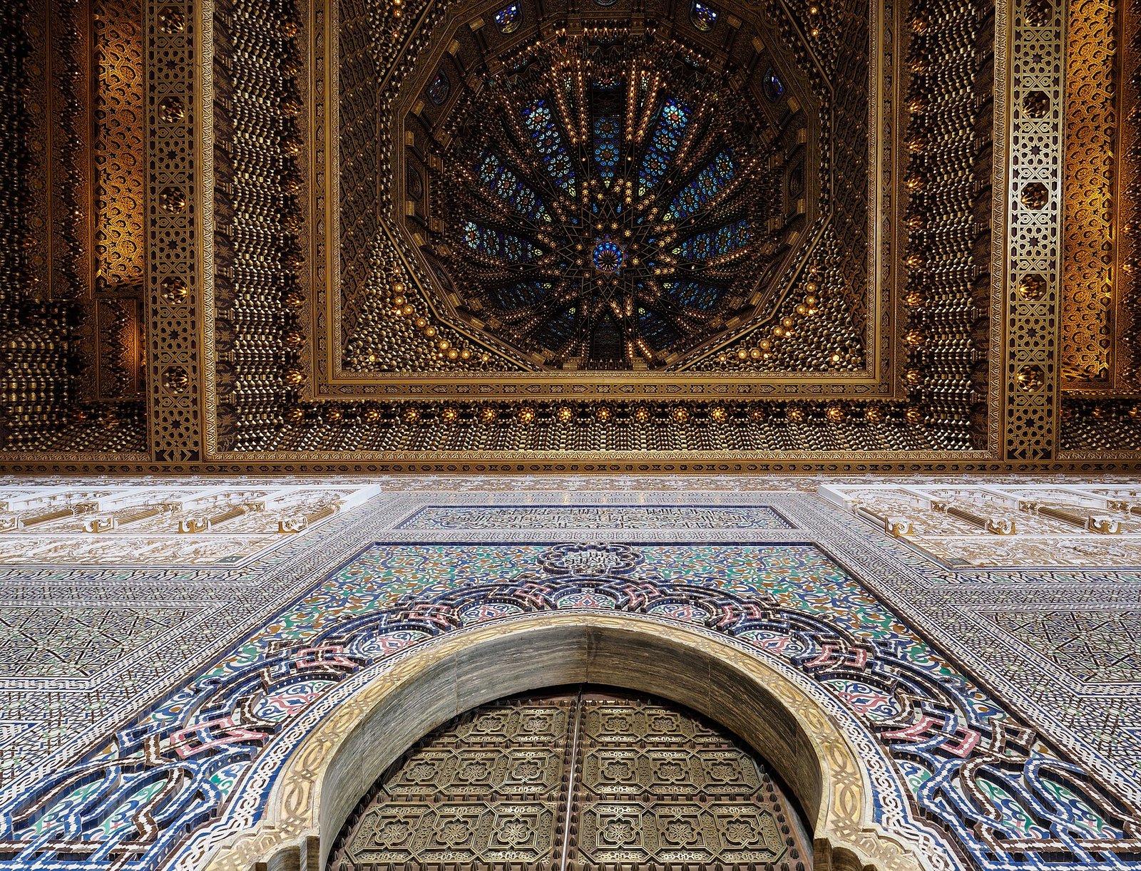 The carved cedar ceiling, gilded doors and zellige tilework inside the Mausoleum of Mohammed V, Rabat.